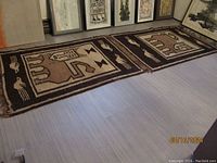 Two handwoven Ethiopian kilim rugs laid side by side on the floor showing their size and design continuity.