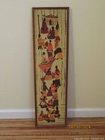 Full view of the entire framed African folk art painting showing the elongated vertical composition and outlined figures.