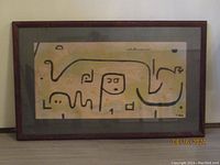 Photo showing entire framed print in dark wood frame, abstract black line art on pale background.