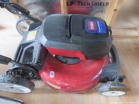 Side angle of Toro 21-inch Recycler electric lawn mower showing Flex-Force power system label and grass catcher attachment.