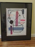 Framed abstract print poster showing Joan Miro's "Female Torso" with geometric shapes and color blocks in a black frame.
