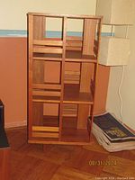 Front view of wooden Danish modern revolving bookcase showing open multiple compartments