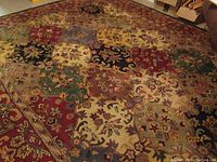 Top view of the multi color floral patchwork area rug showing detailed pattern and colors