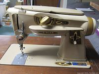 Front and side views of Singer Model 500A sewing machine in beige, showing controls, needle area, and branding.