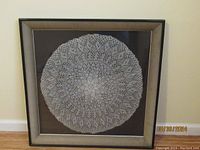 Front view of framed vintage crochet doily showing entire piece in frame.