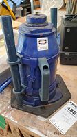Front angle view of blue Kobalt hydraulic bottle jack with handle and base showing label and general condition.
