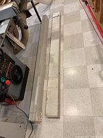 Two packages of cedar clap board planks, each approximately 5.5 inches wide, stacked on the floor.