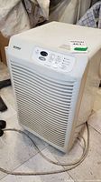 Front view of the white Kenmore dehumidifier with control panel and power cord
