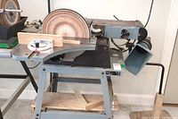 Front view of Delta 31-280 sanding center on stand with dust port