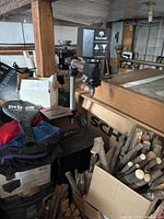 Rockwell radial drill press shown in a basement setting with nearby boxes and firewood, highlighting size and condition.