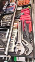 Top view of drawer with adjustable wrenches, screwdrivers, riveters, small hardware bits