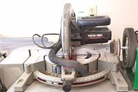 Front-left angle view showing saw blade, motor housing and sliding rails