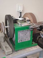 Front view of green Tormek Super-Grind 2000 machine with grinding wheels