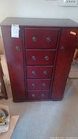 Front view of dark reddish-brown wooden storage cabinet with five drawers and side compartment.