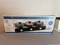 Front view of the Bella triple slow cooker buffet and serve unit box showing product image and branding.