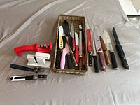 Top view showing full assortment of knives and sharpeners on a cloth surface.