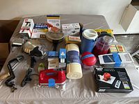 Photo showing the entire lot of kitchen gadgets including vintage handheld mixer, pineapple slicer, chopppers, food scale, and assorted boxed items.