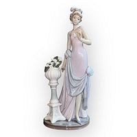 Front three-quarter view of figurine and urn showing overall form and missing cup