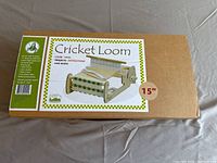 Box packaging for 15-inch Cricket Loom weaving machine, showing brand and included contents