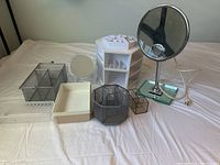 Lot with all makeup storage bins and electric oval mirror displayed together on a white sheet.