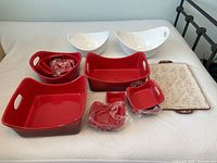 Overall view of Mikasa branded red and white serving containers and trays with some wear