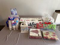 Group view of all paper napkins, tissue rolls, and disposable cups included in the lot