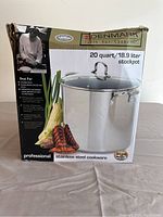 Boxed Denmark 20 quart/18.9 liter stock pot with packaging showing product features and usage suggestions.