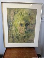 Overall front view of framed painting showing abstract face composition.