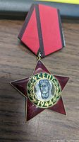 Red star-shaped WWII Bulgarian medal with soldier portrait and 9 September 1944 inscription.