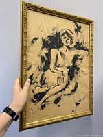 Front view of dramatic nude lady India ink sketch in gilt wood frame held upright.