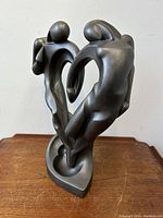 Side view of abstract soulmate sculpture showing two stylized human figures intertwined forming heart shape