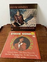 Front covers of the two vinyl LP albums: Stevie Wonder's Talking Book and Someday at Christmas.