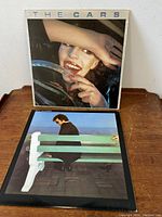 Front and back views of The Cars and Boz Scaggs vinyl LP covers with records inside