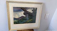 Framed lithograph artwork showing stylized raven and landscape.