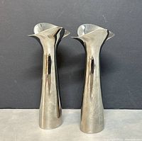 Front view of both candle holders on dark background