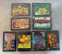 All eight framed postcards arranged in two rows showing colorful abstract art in the style of Hundertwasser.