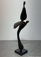Front view of dark abstract steel sculpture on square base, signed by Boris Kramer