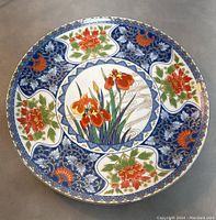 Full front view of the vintage Japanese Imari porcelain platter showing the detailed hand-painted floral and blue arabesque patterns.