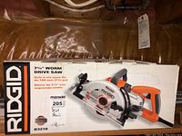 Front of box showing Rigid branding, model R3210, and saw image