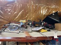 Two Bosch angle grinders, assorted discs and saw blades on shelving