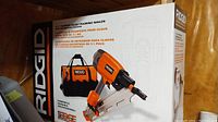 Front of box showing Ridgid branding and framing nailer image
