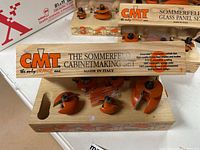 Six orange router bits in wooden case labeled 'The Sommerfeld Cabinetmaking Set'