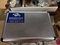 Closed aluminum carrying case with Elite Tools branding and foam lining visible