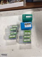 Eight plastic cases arrayed on table, showing mix of brands and labels.