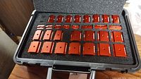 Overview of foam-lined case with red anodized gauge blocks, two empty slots visible.