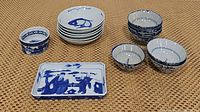 Photo showing all items in the lot: 7 small rice bowls, 6 fish design bowls, one 5-inch bowl, and one rectangular tray with figure design.