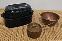 Set showing three vintage kitchen pans: black splatter roasting pot with lid, large copper mixing bowl, and small hammered copper lidded pot with handle.