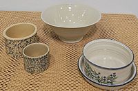 Photo showing all five items: two vintage stoneware crocks with blue splatter design, fluted cream ceramic bowl, blueberry pattern casserole dish, and matching plate.