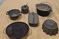 Overview of all six vintage cooking kitchen items on woven surface