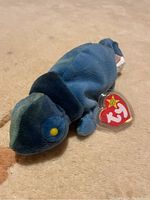 Plush chameleon Beanie Baby with original Ty heart-shaped tag and tag protector, close-up on side.